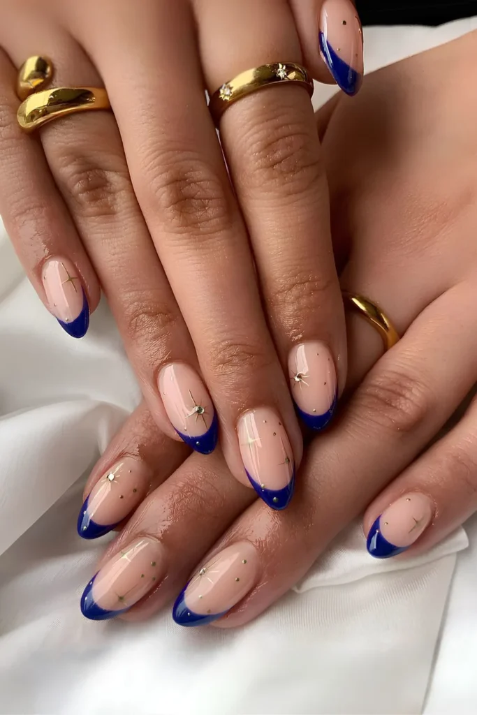 10 Nail Colors That Never Go Out of Style (Timeless Trends) 7 Navy blue French mani with celestial charms.jpg