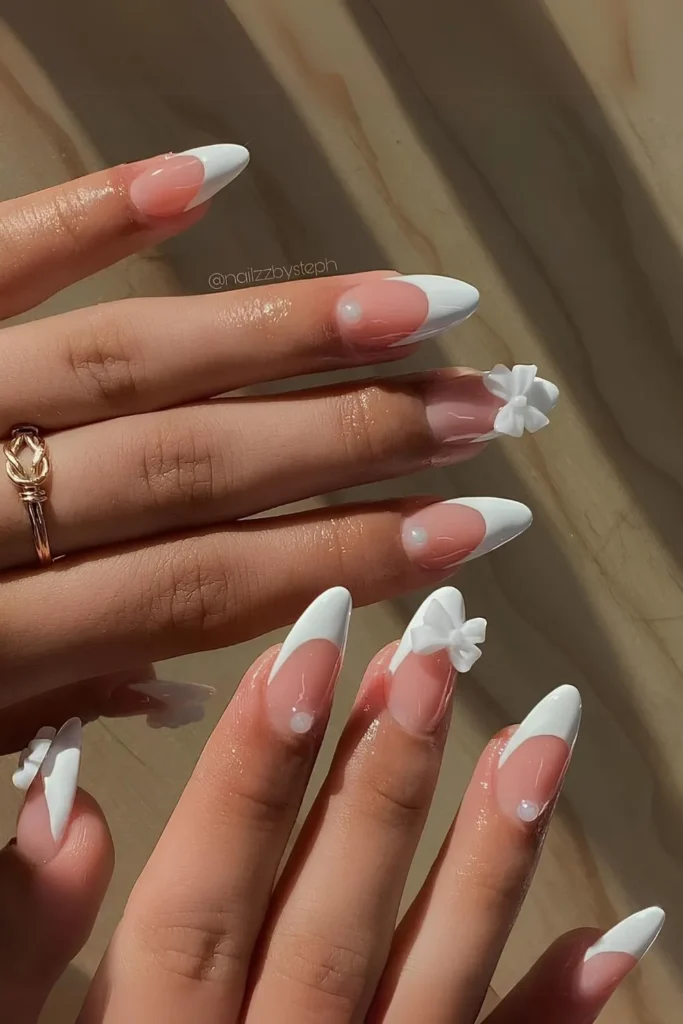 10 Nail Colors That Never Go Out of Style (Timeless Trends) 10 White French nails with pearls and 3D bows.jpg