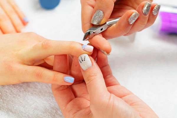 How to Make Your Manicure Last Longer (Salon & DIY Tips) 3 pushing back cuticles thumb